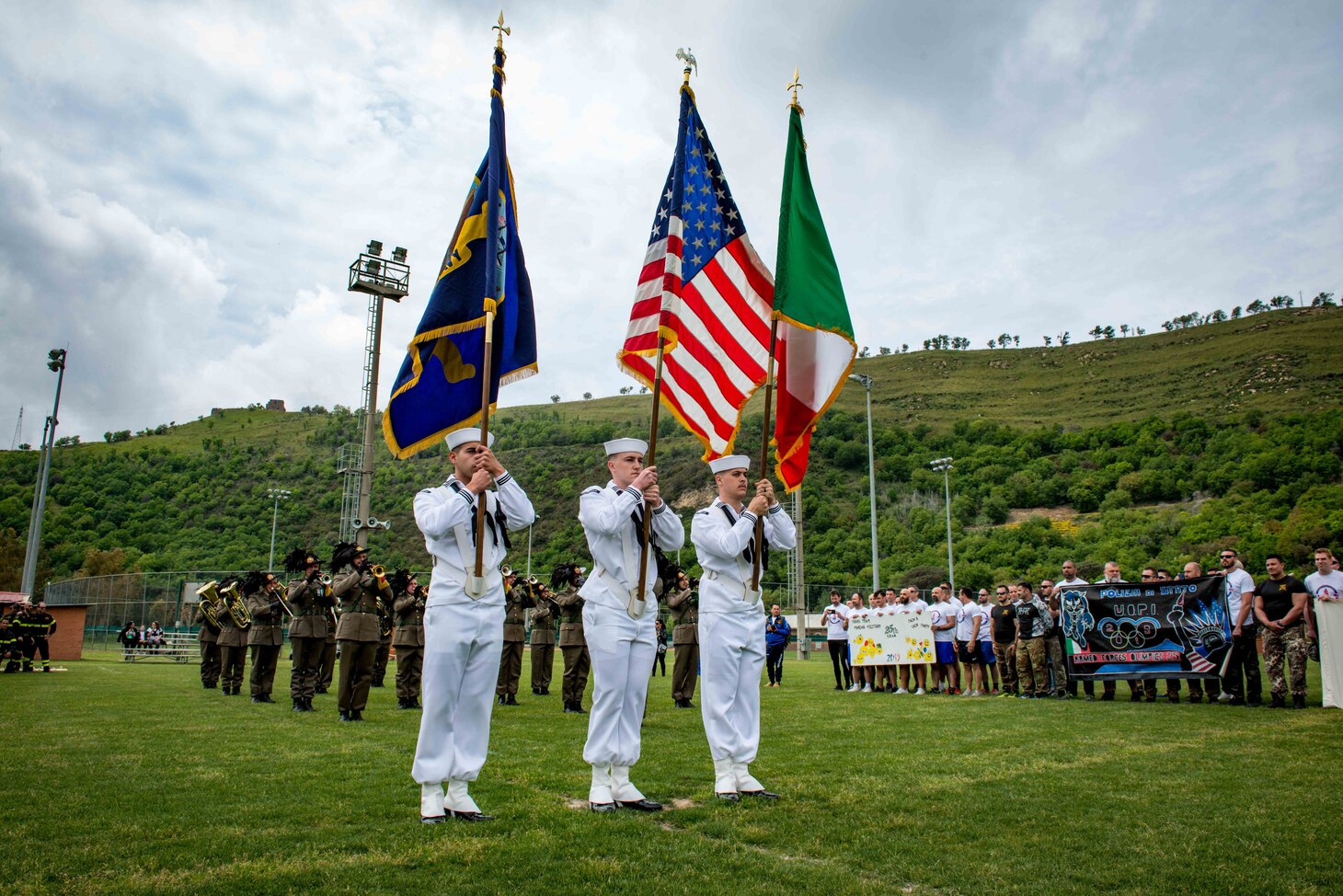 U.S. and Italian service members stand for the national anthems during the opening ceremony of the Naples Armed Forces Olympics in Naples, Italy, May 3, 2019.