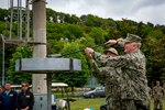 dm. James G. Foggo III, commander, U.S. Naval Forces Eruope-Africa and commander, Allied Joint Force Command Naples, Italy, and Capt. Todd Abrahamson, commander, U.S. Naval Support Activity Naples, light a torch during the opening ceremony of the Naples Armed Forces Olympics in Naples May 3, 2019.