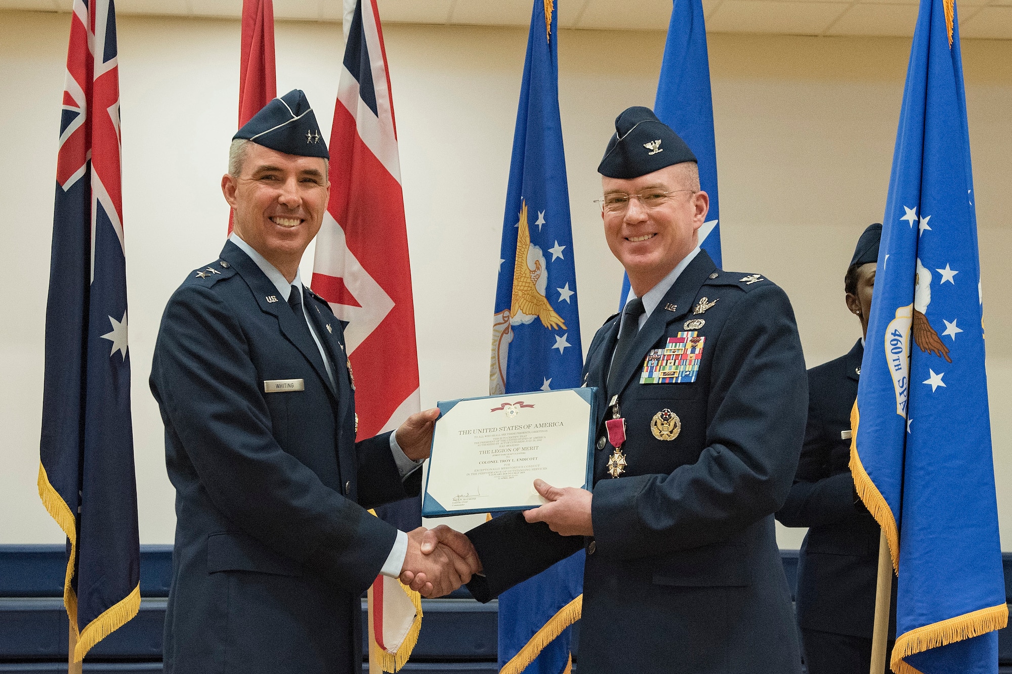 Maj. Gen. Stephen Whiting, 14th Air Force commander, presents the Legion of Merit medal to Col. Troy Endicott, 460th Space Wing outgoing commander, at the 460th SW change of command ceremony May 3, 2019, on Buckley Air Force Base, Colorado.