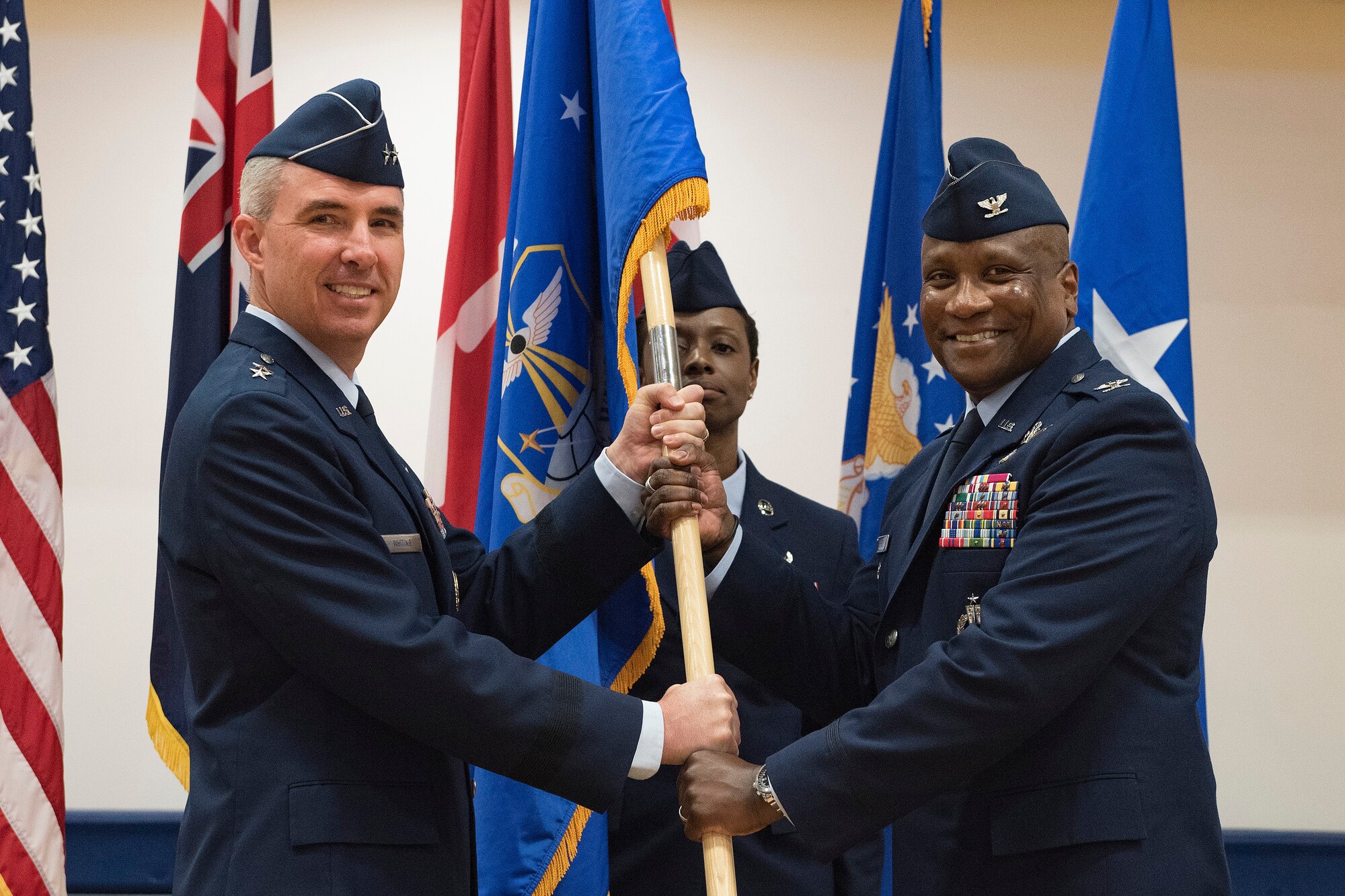 Maj. Gen. Stephen Whiting, 14th Air Force commander, presents the guidon to Col. Devin Pepper, 460th Space Wing commander, during a Change of Command ceremony May 3, 2019, on Buckley Air Force Base, Colorado.