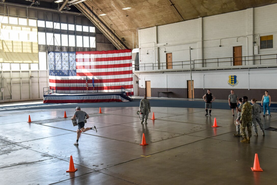 Senior Airman Wesley Tyner, 28th Logistics Readiness Squadron vehicle operations control center support, runs with full-barrel keg that had been half filled with sand during the Ellsworth Air Force Base’s Strongest Competition at the Pride Hangar on Ellsworth AFB, S.D., April 25, 2019. The keg weighed between 60-70 pounds, and competitors raced to see who could complete the quickest lap while carrying it. The keg run was one of the event’s five tests of strength, which also included a max-out deadlift, farmer’s carry, tire flip and vehicle pull. (U.S. Air Force photo by Tech. Sgt. Jette Carr)