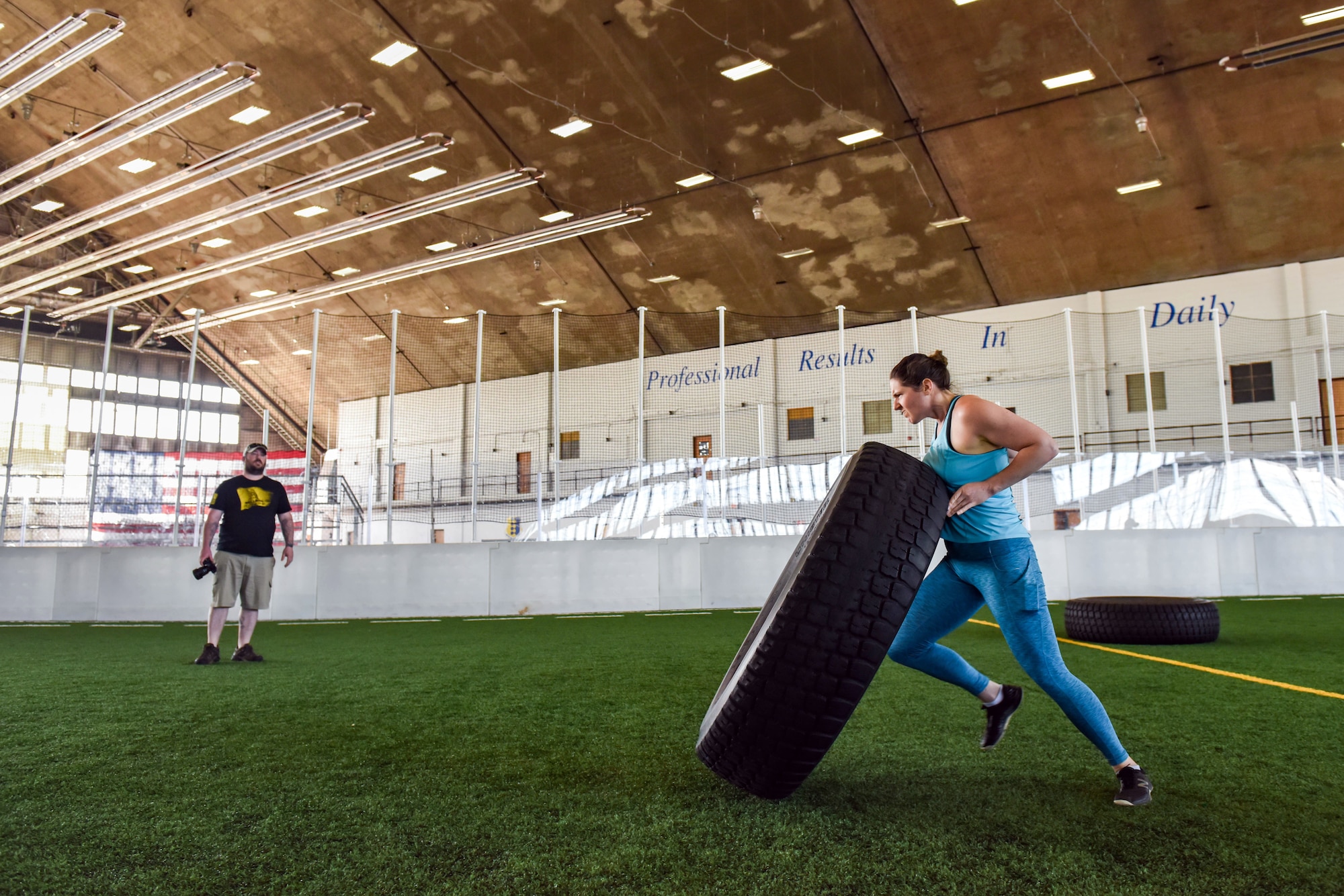 Eugene Weaver, a military spouse, flips a tire down the Pride Hangar’s turf field during the Ellsworth Air Force Base’s Strongest Competition on Ellsworth AFB, S.D., April 25, 2019. The free sporting event was hosted by the 28th Force Support Squadron. Competitors performed feats of strength throughout five different exercises: max-out deadlift, farmer’s carry, keg run, tire flip and vehicle pull. Weaver placed third in the strongest female category. (U.S. Air Force photo by Tech. Sgt. Jette Carr)