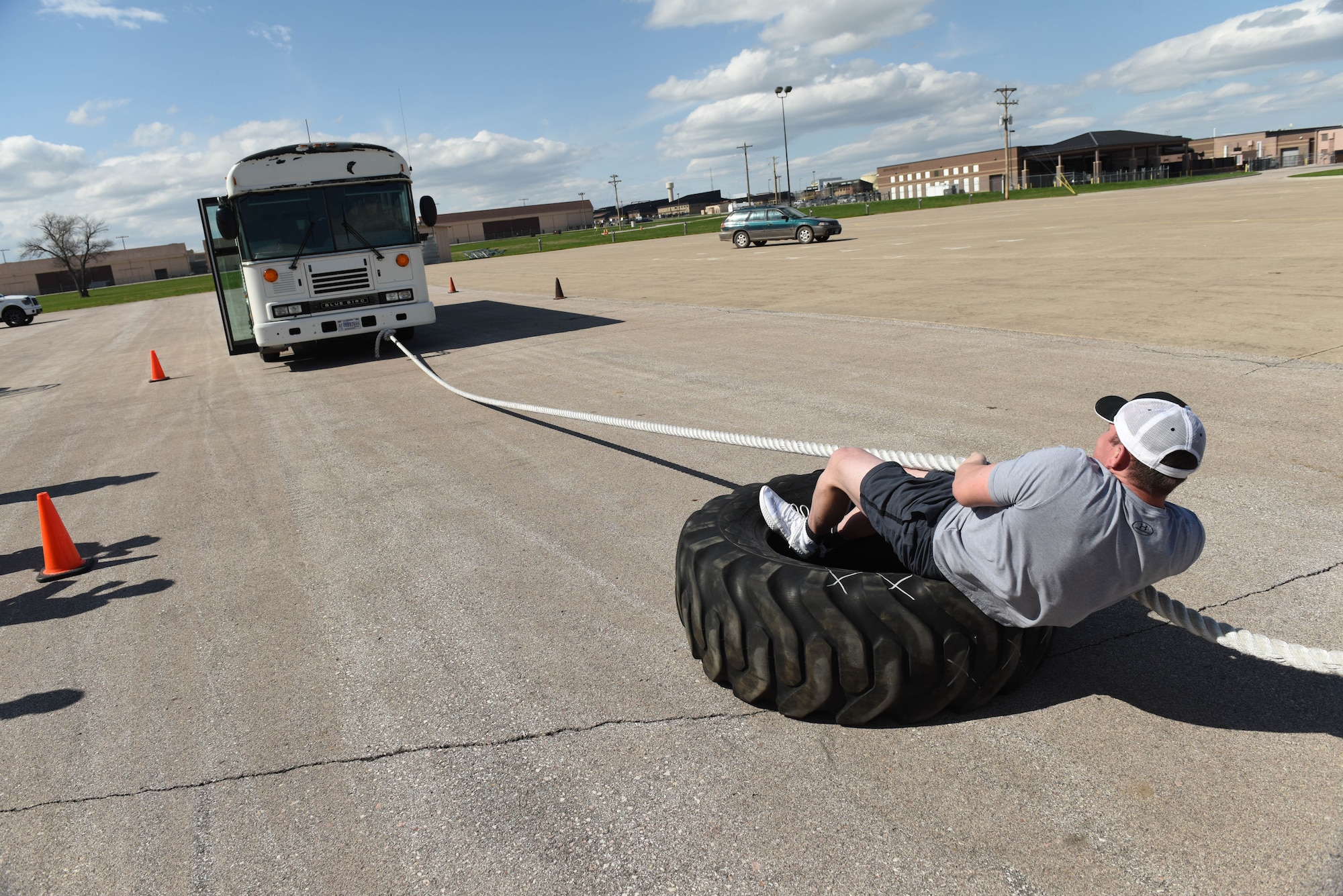 Senior Airman Wesley Tyner, 28th Logistics Readiness Squadron vehicle operations control center support, pulls a bus forward during the Ellsworth Air Force Base’s Strongest Competition at the Pride Hangar parking lot on Ellsworth AFB, S.D., April 25, 2019. Tyner succeeded in his efforts, muscling the bus to the cones that signified the finish line for that event. The vehicle pull was one of five feats of strength used to determine who would go home with the title of strongest man or woman on base. Other areas of the competition included a max-out deadlift, farmer’s carry, keg run and tire flip. (U.S. Air Force photo by Tech. Sgt. Jette Carr)