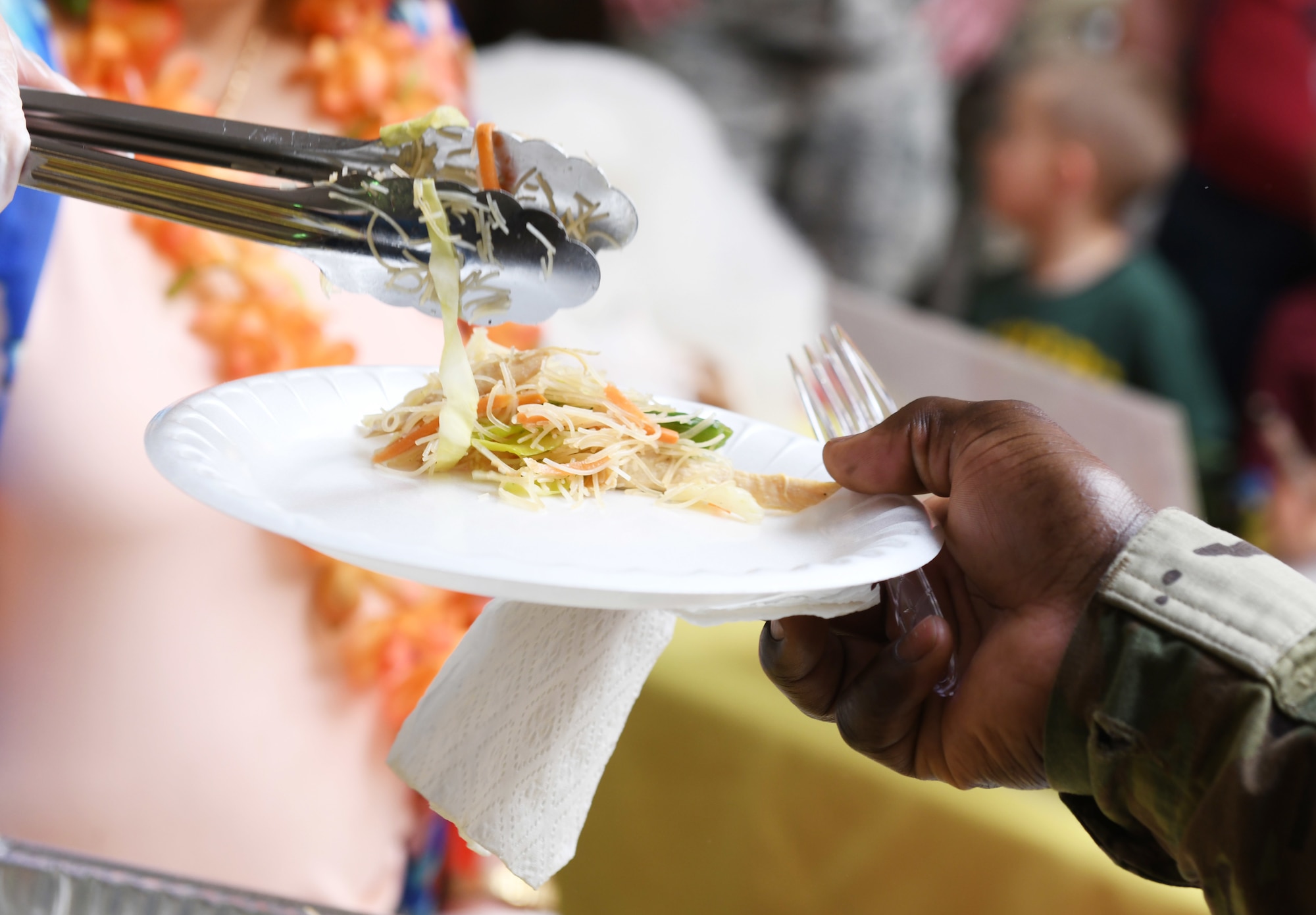 Tech. Sgt. Jermaine Wright, a 28th Munitions Squadron conventional maintenance technician, puts together a plate during a food tasting event on Ellsworth Air Force Base, S.D., May 3, 2019. Volunteers prepared several foods influenced by Asian and Pacific Islander cultures and served them to Airmen and their families. (U.S. Air Force photo by Senior Airman Thomas Karol)