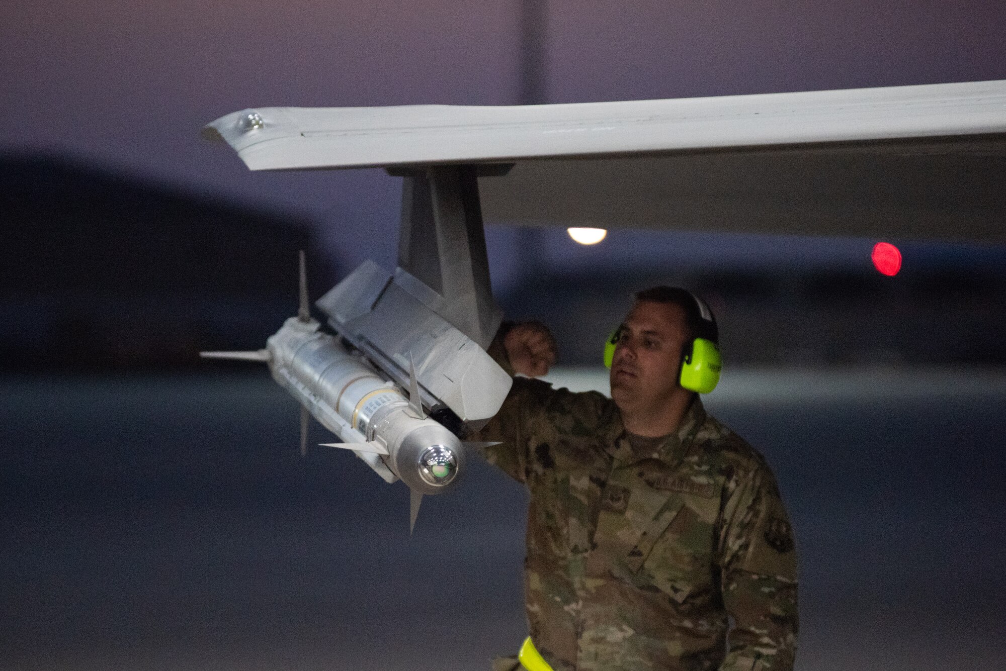 Staff Sgt. Karl Tesch, 380th Expeditionary Aircraft Maintenance Squadron weapons load crew chief, performs an inspection prior to launch check on an F-35A Lightning II April 26, 2019, at Al Dhafra Air Base, United Arab Emirates.