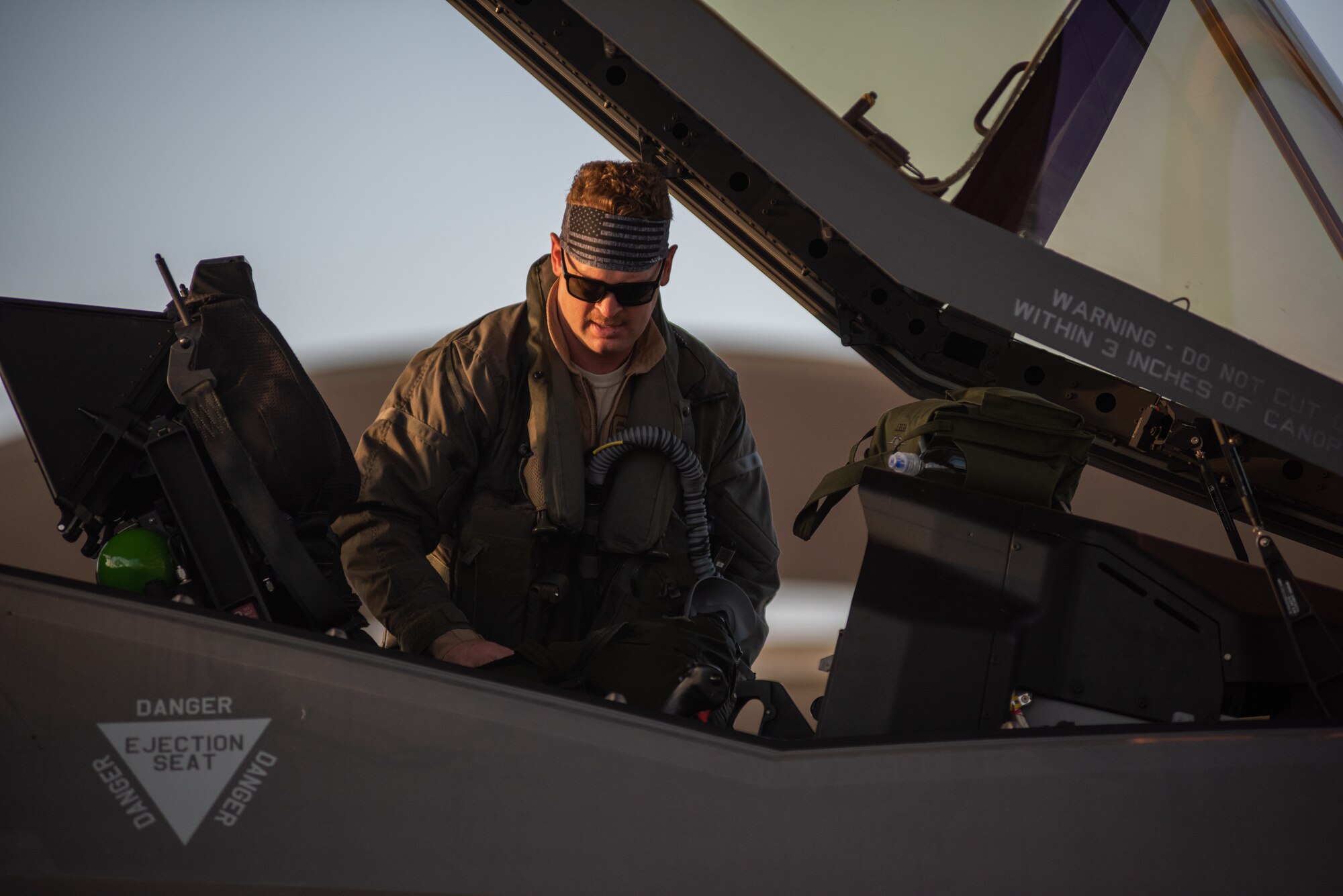 A pilot from 4th Expeditionary Fighter Squadron climbs into an F-35A Lightning II April 26, 2019, at Al Dhafra Air Base, United Arab Emirates.