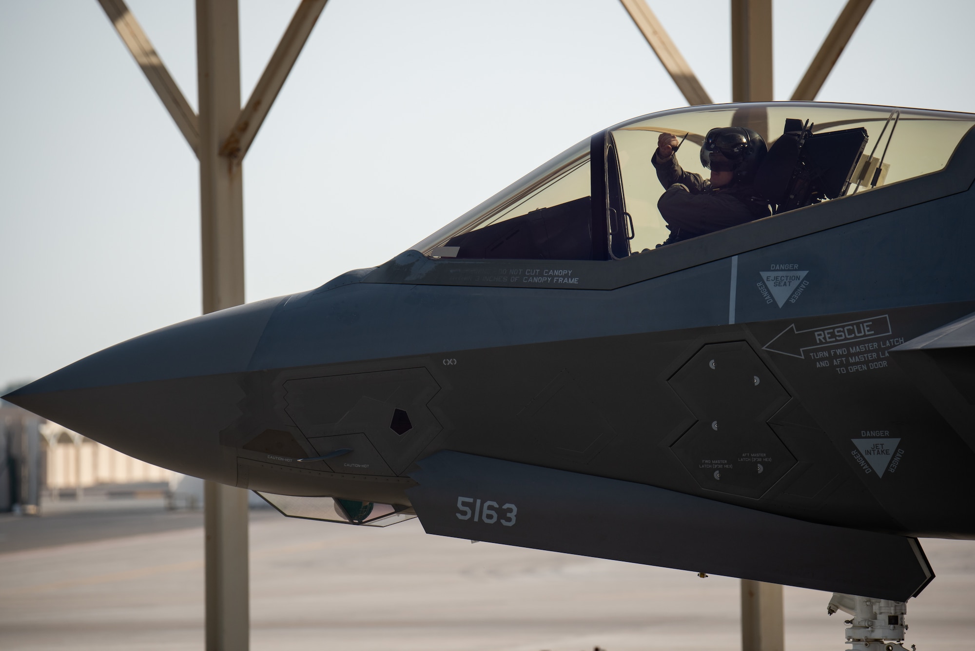A pilot from 4th Expeditionary Fighter Squadron F-35A Lightning II pilot gestures to the crew chief into an April 26, 2019, at Al Dhafra Air Base, United Arab Emirates.