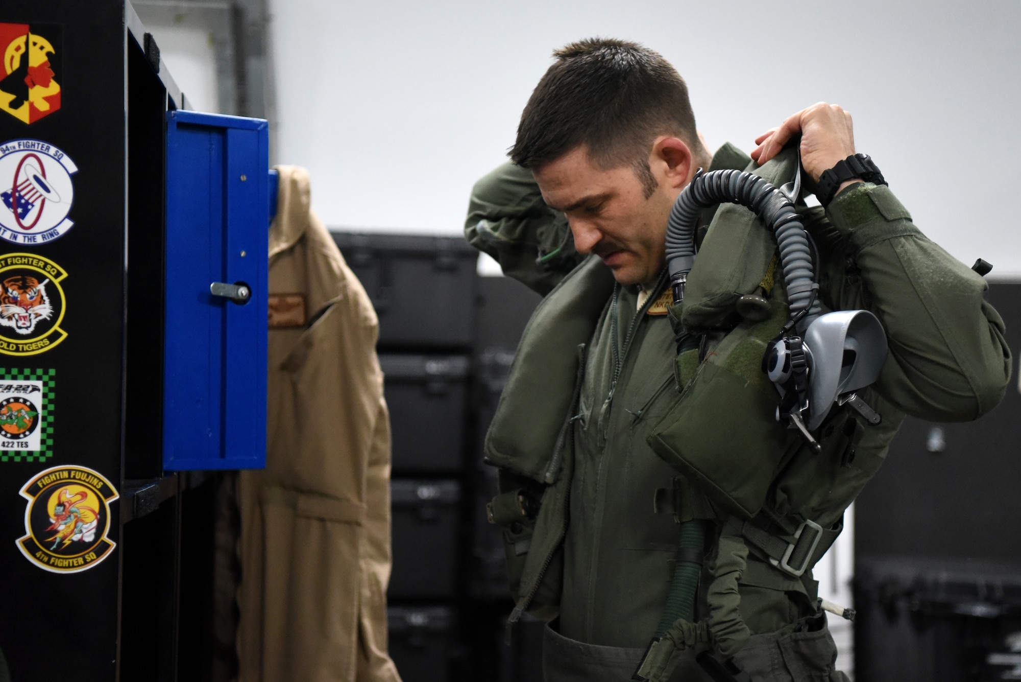 An F-35A Lightning II pilot assigned to the 4th Expeditionary Fighter Squadron dons a sleeveless flight jacket in preparation for the first combat sortie in the U.S. Air Forces Central Command area of responsibility April 26, 2019, Al Dhafra Air Base, United Arab Emirates.