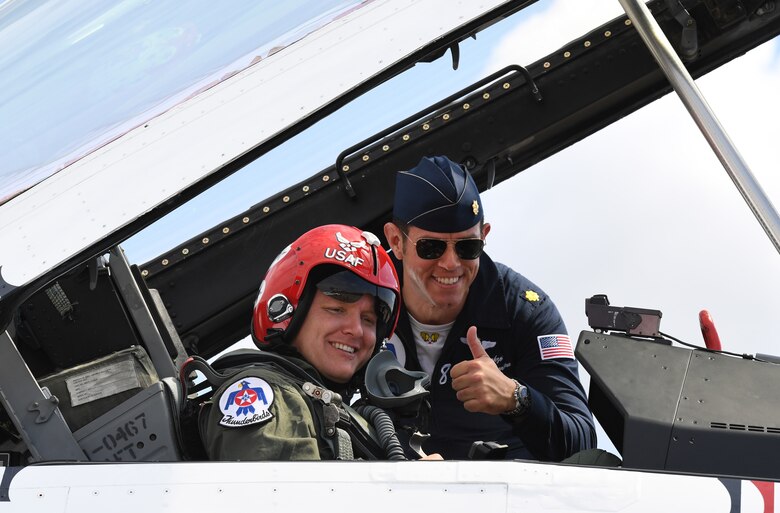 U.S. Air Force Maj. Jason Markzon, Thunderbird #8, and Destin Sandlin, Smarter Every Day host, pose for a photo inside an F-16 Flying Falcon prior to Sandlin's incentive flight in Gulfport, Mississippi, May 3, 2019. The Thunderbirds are headlining the unique joint air show with the city of Biloxi and Keesler AFB, May 4-5. The two-day event will also include various static displays on the flightline on base and aerial performances over the beach. (U.S. Air Force photo by Kemberly Groue)