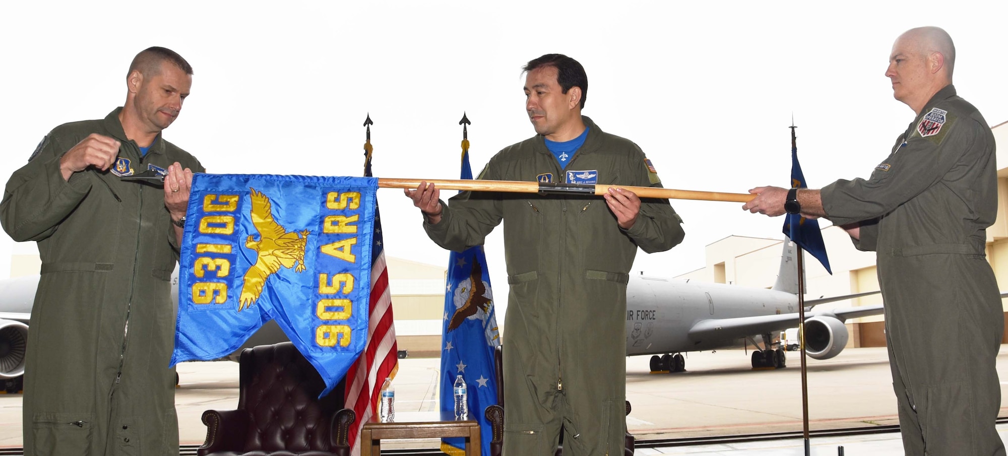 (Left to right) Col. Phil Heseltine, 931st Air Refueling Wing commander, Lt. Col. Eric Rivero, the incoming 905th Air Refueling Squadron commander, and retired Col. Noel Bradford, the previous commander of the 905 ARS, unfurl the 905 ARS guidon during an official ceremony, May 4, 2019, McConnell Air Force Base, Kan. The 905 ARS was the first Air Force flying unit to be assigned to Grand Forks, and it received its first KC-135 Stratotanker in 1960.  The unit stayed at Grand Forks Air Force Base, N.D., until it was deactivated in 2010.