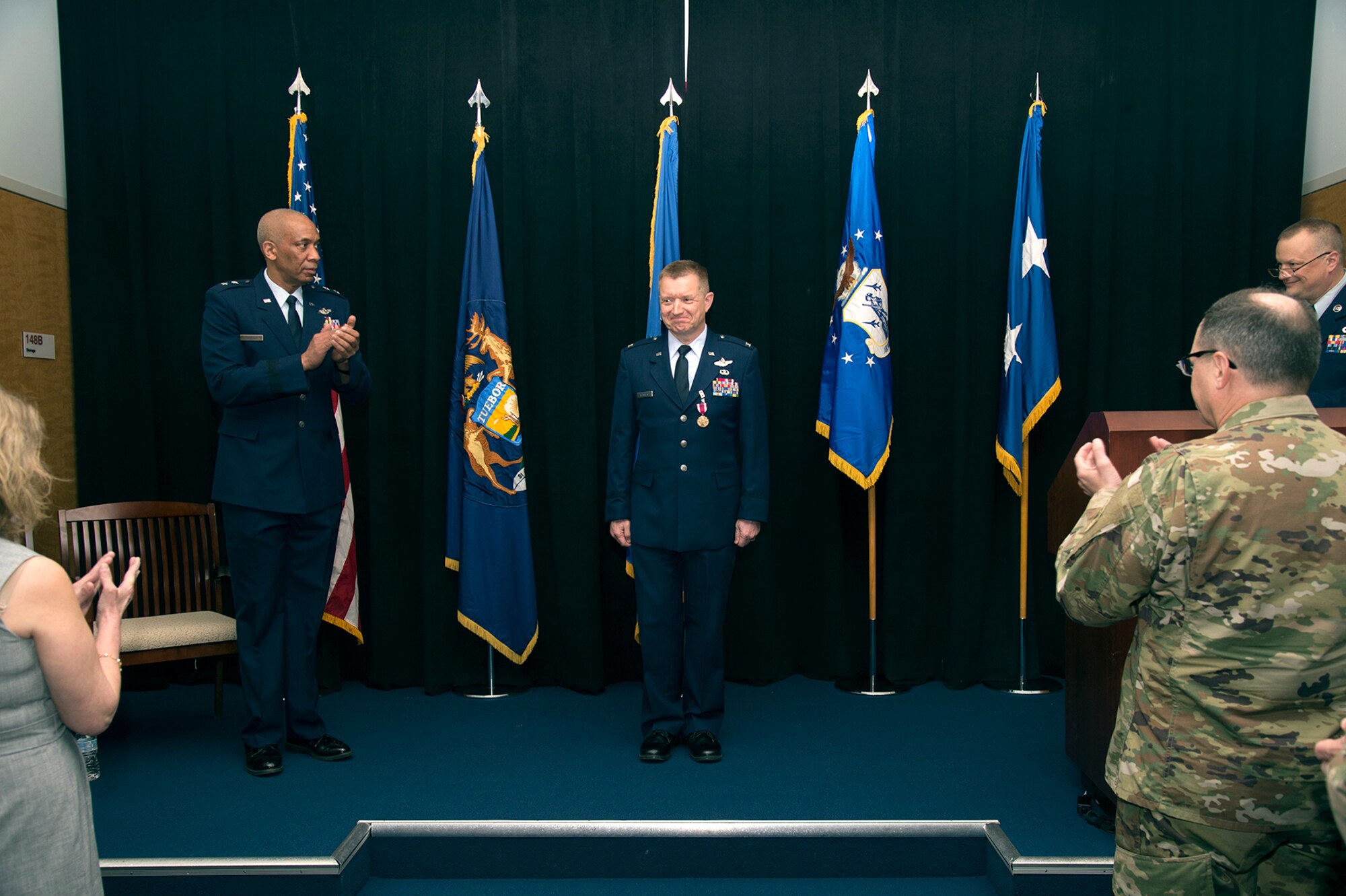 Brig. Gen. Rolf E. Mammen, commander of the 127th Wing and Selfridge Air National Guard Base, receives applause from Maj. Gen. Leonard Isabelle, commander of the Michigan Air National Guard and the audience during his promotion ceremony here, May 4, 2019.