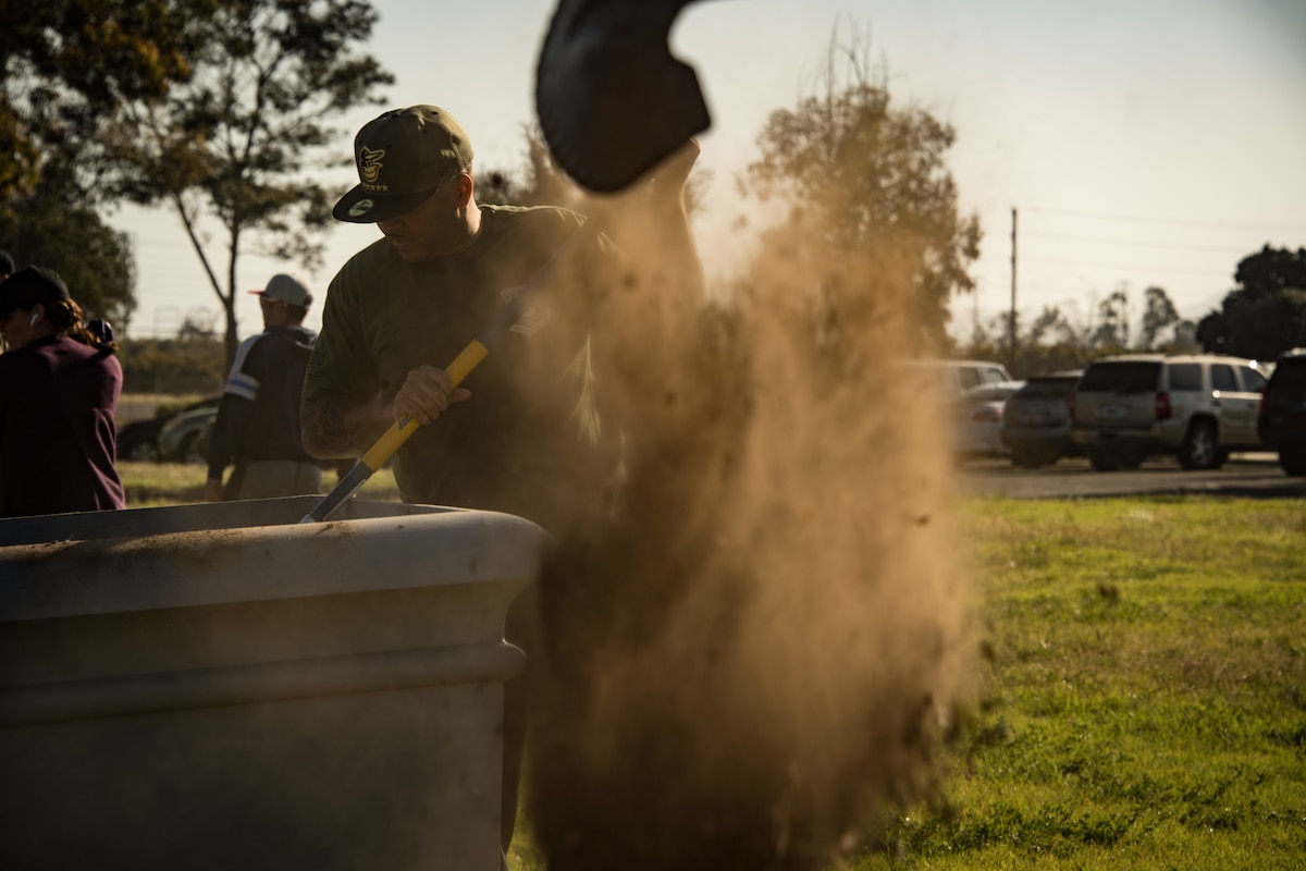 U.S. Air National Guard Maj. Shane Patty removes dirt from a planter at the Channel Islands Air National Guard Station April 22, 2019. Patty and volunteer airmen used Earth Day as a platform to make beautification improvements to the base. (U.S. Air National Guard photo by Tech. Sgt. Nieko Carzis)