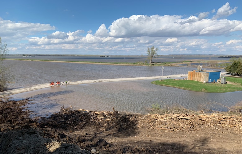 Crews pump water to keep an access road in Peru, Nebraska, from overtopping.