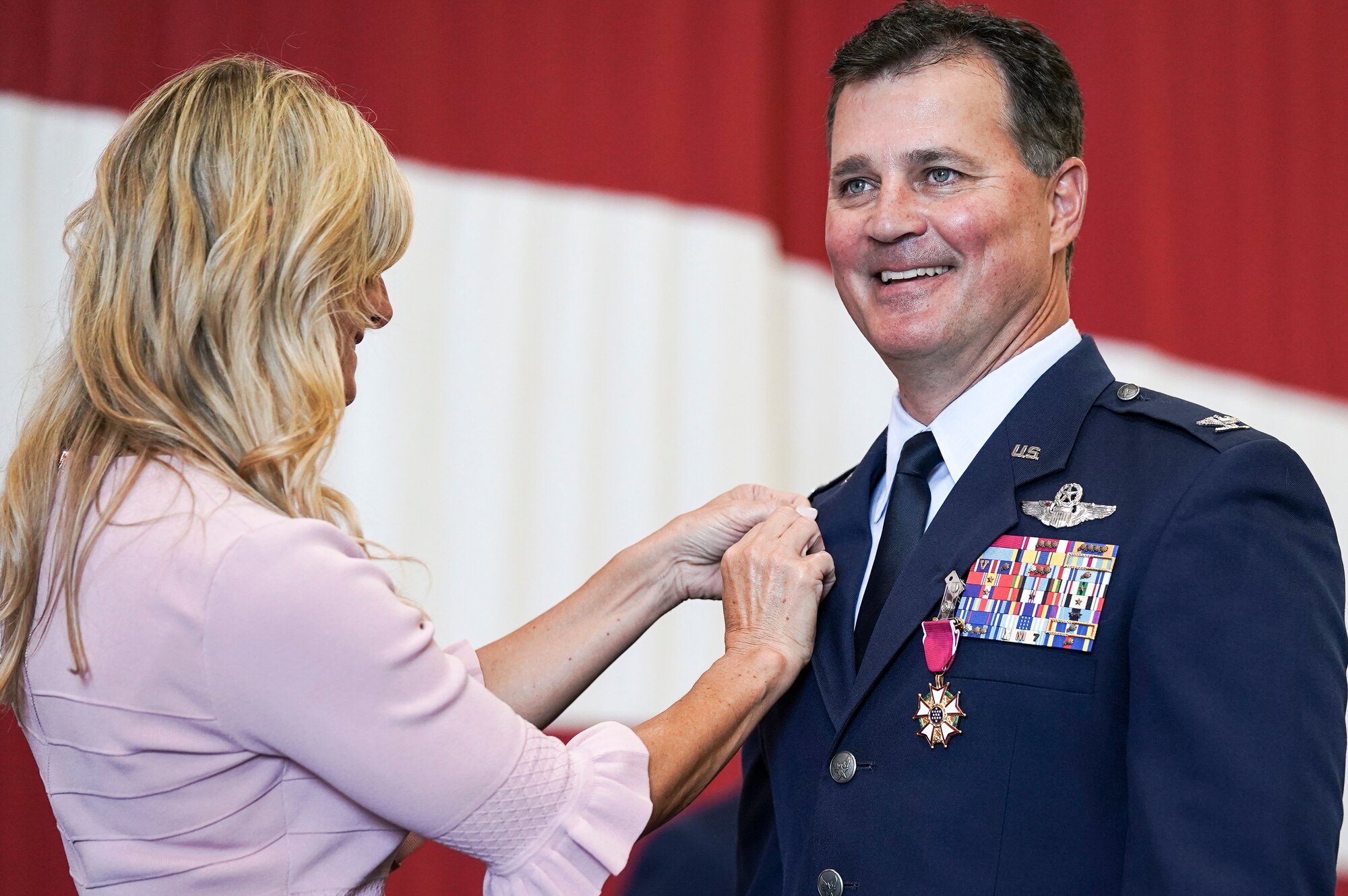 Col. Devin R. Wooden, former 137th Special Operations Wing commander, receives a retirement pin from his wife, Kelly Wooden, during his retirement ceremony at Will Rogers Air National Guard Base, May 5, 2019. Wooden spent his entire career, nearly 33 years, promoting from Airman 1st Class to Colonel in the Oklahoma Air National Guard. (U.S. Air National Guard photo by Staff Sgt. Tyler Woodward)