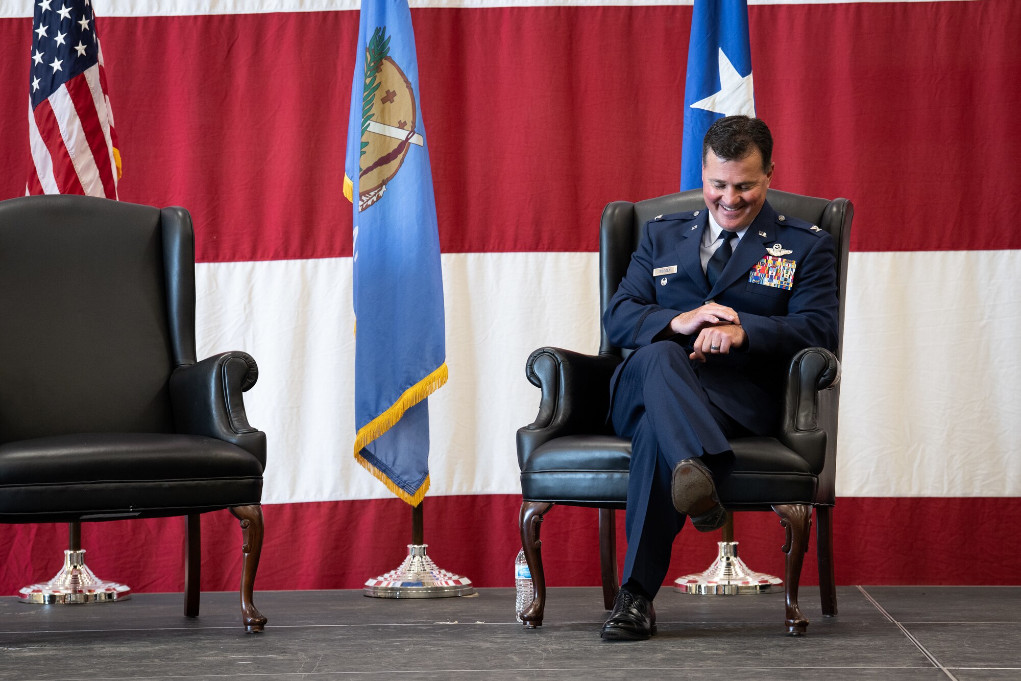 Col. Devin R. Wooden, former 137th Special Operations Wing commander, jokingly checks his watch during his retirement ceremony at Will Rogers Air National Guard Base, May 5, 2019. Wooden spent his entire career, nearly 33 years, promoting from Airman 1st Class to Colonel in the Oklahoma Air National Guard. (U.S. Air National Guard photo by Senior Airman Jordan Martin)