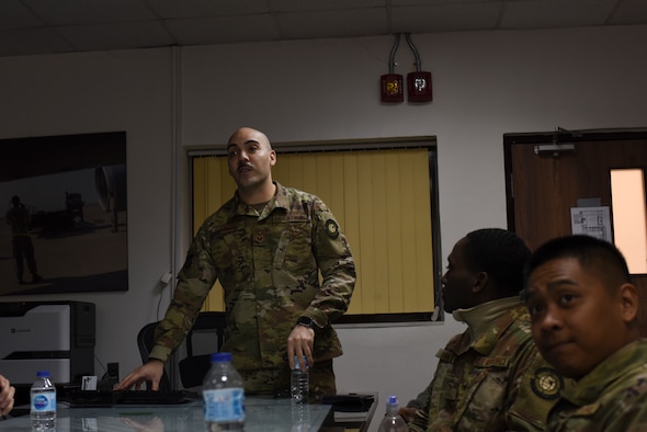 Staff Sgt. Matthew Bertini, 728th Air Mobility Squadron passenger services supervisor, briefs members on new Air Force regulations March 6, 2019, at Incirlik Air Base, Turkey. The 728th AMS leadership created a Solutions Group comprised of junior Airmen and NCOs designed to build confidence, solve problems and allow them to own their sections while making failures in a safe environment. (U.S. Air Force photo by Staff Sgt. Matthew J. Wisher)