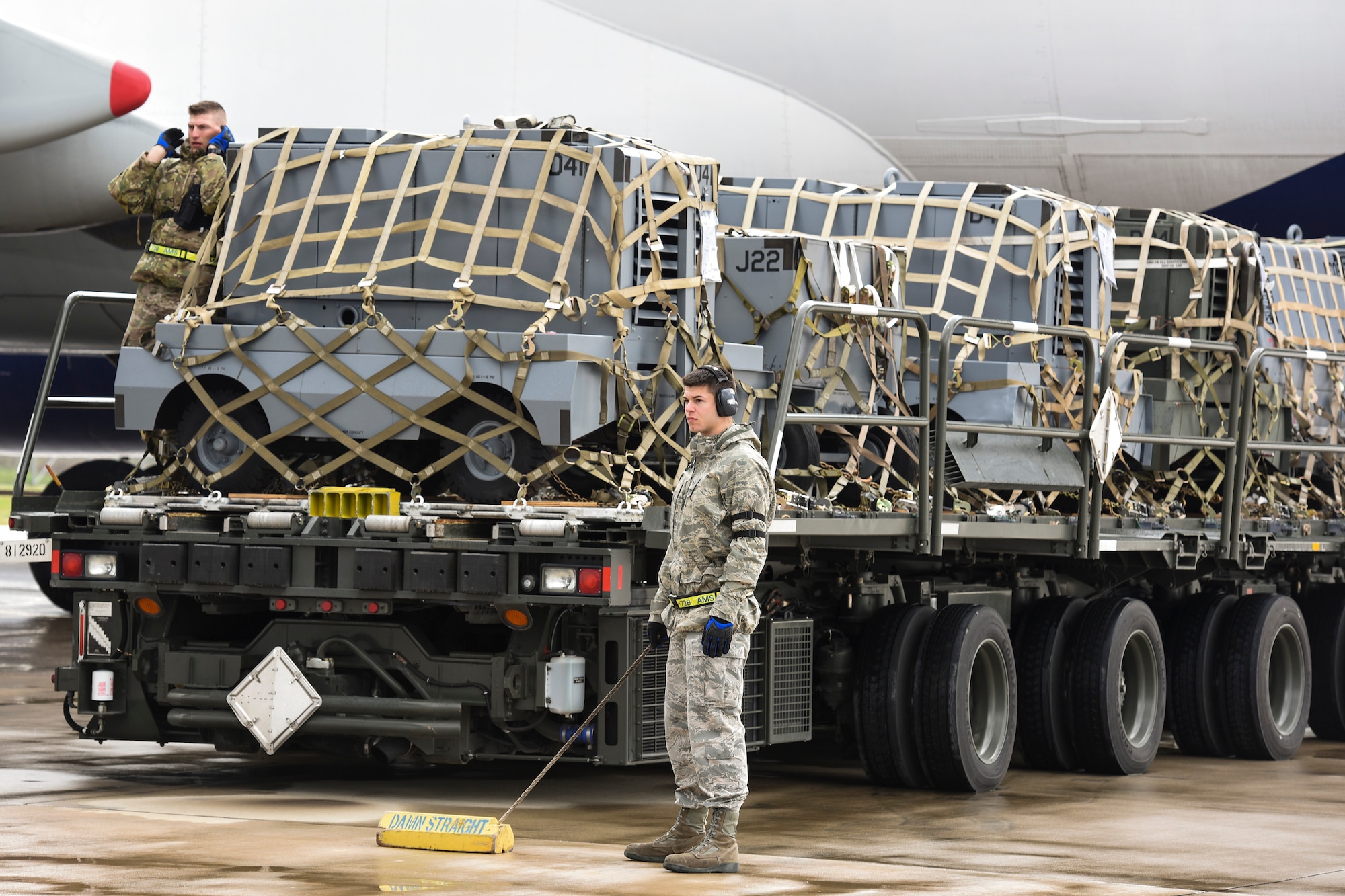 Staff Sgt. Daniel Lauritzen, 728th Air Mobility Squadron aircraft services supervisor, and Senior Airman Dane Johnson, 728th AMS aircraft services journeyman, direct a K-Loader into place March 3, 2019, at Incirlik Air Base, Turkey. Airmen in the 728th AMS use K-loaders to offload and download thousands of pounds of cargo weekly. (U.S. Air Force photo by Staff Sgt. Ceaira Tinsley)