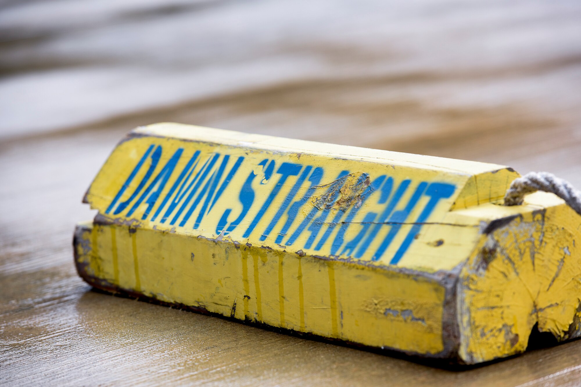 A 728th Air Mobility Squadron chock etched with the unit’s motto “Damn Straight” rests on the flightline March 3, 2019, at Incirlik Air Base, Turkey. The 728th AMS ensures the base has necessary supplies and is ready as a power projection platform. (U.S. Air Force photo by Staff Sgt. Ceaira Tinsley)