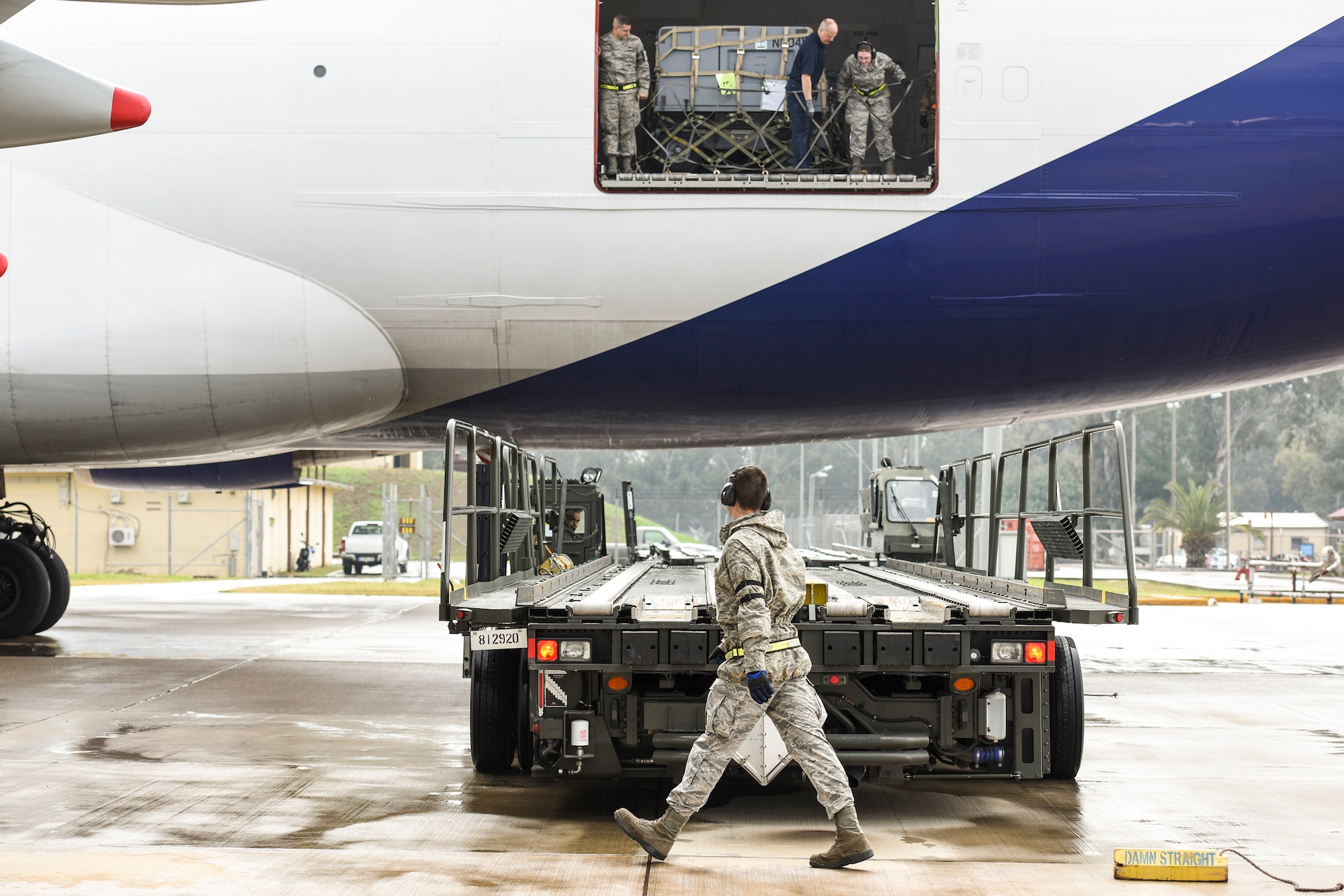 Senior Airman Dane Johnson, 728th Air Mobility Squadron aircraft services journeyman, puts a chock in place March 3, 2019, at Incirlik Air Base, Turkey. Airmen from the 728th AMS offload various types of cargo including food rations, mail and maintenance parts. (U.S. Air Force photo by Staff Sgt. Ceaira Tinsley)
