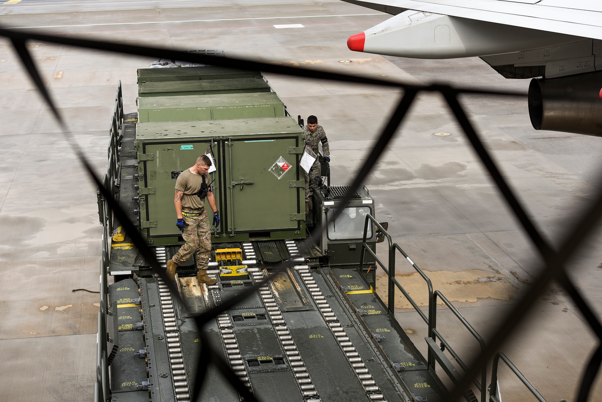 Staff Sgt. Daniel Lauritzen, 728th Air Mobility Squadron aircraft services supervisor, and Senior Airman Dane Johnson, 728th AMS aircraft services journeyman, unload cargo from a K-Loader March 3, 2019, at Incirlik Air Base, Turkey. Airmen in the 728th AMS use K-loaders to offload and download thousands of pounds of cargo weekly. (U.S. Air Force photo by Staff Sgt. Ceaira Tinsley)