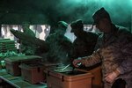 Members of the 445th Force Support Squadron serve breakfast during the 445th Airlift Wing’s annual Agile Combat Support exercise at the Warfighter Training Center April 7, 2019.