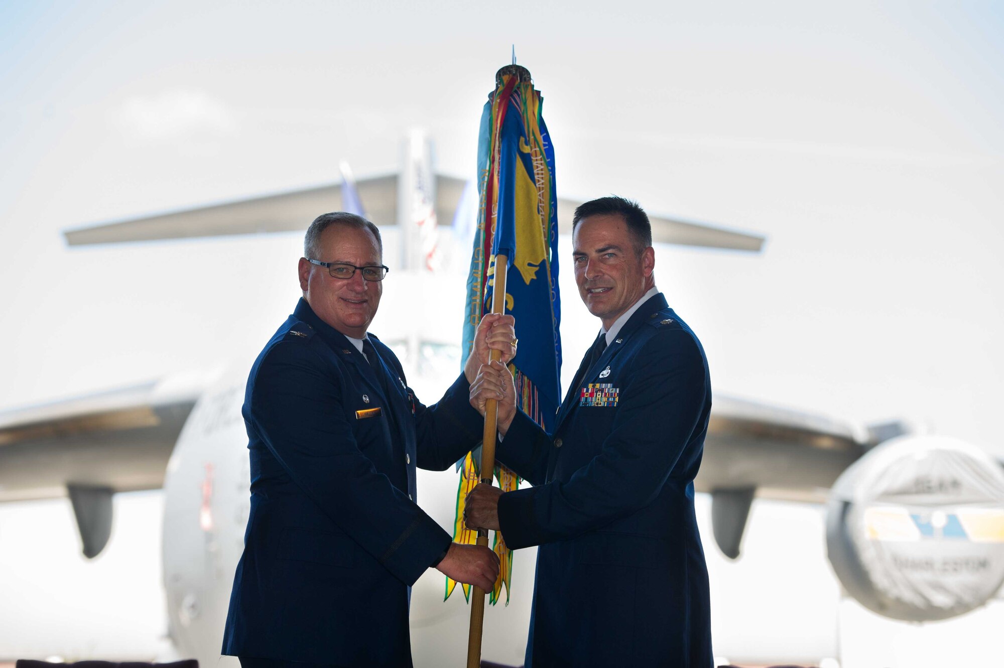 Lt. Col. Taylor Adams (right) receives the 315th Maintenance Squadron guidon from Col. Thomas Walter, 315th Maintenance Group commander, during a change-of-command ceremony Saturday, May 4, 2019, at Joint Base Charleston, S.C.