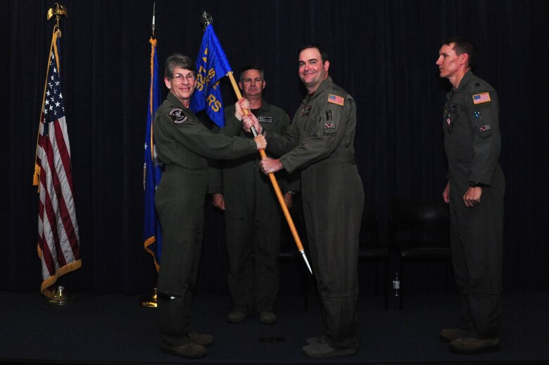 Col. Caroline Evernham, commander of the 927th Operations Group, hands over the guideon to Lt. Col. Marc R. McAllister during a change of command ceremony May 4, 2019. The ceremony was held during the Unit Training Assembly. (U.S. Air Force photo by Senior Airman Alexis Suarez)