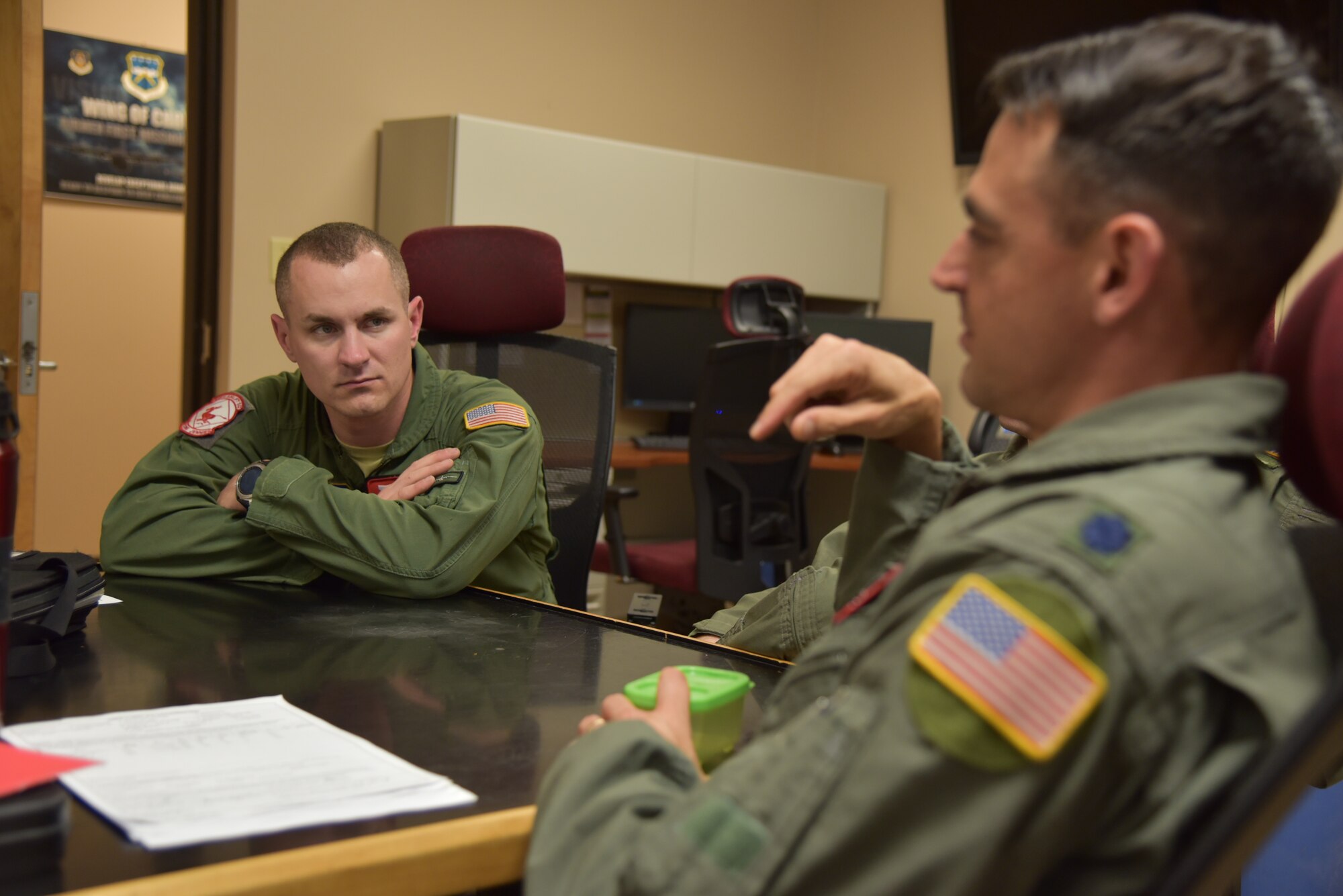 Senior Airman John Boudreaux (left), 815th Airlift Squadron loadmaster, listens to Lt. Col. Stuart Rubio (right), 815th AS commander and pilot, during a post-mission briefing April 18, 2019, Keesler Air Force Base, Mississippi. Boudreaux suffered three fractured vertebra in a car wreck. After receiving surgery and completing physical therapy, he attended loadmaster school for a second time and is in the process of completing his training to become a fully qualified loadmaster.  (U.S. Air Force photo by Tech Sgt. Michael Farrar)