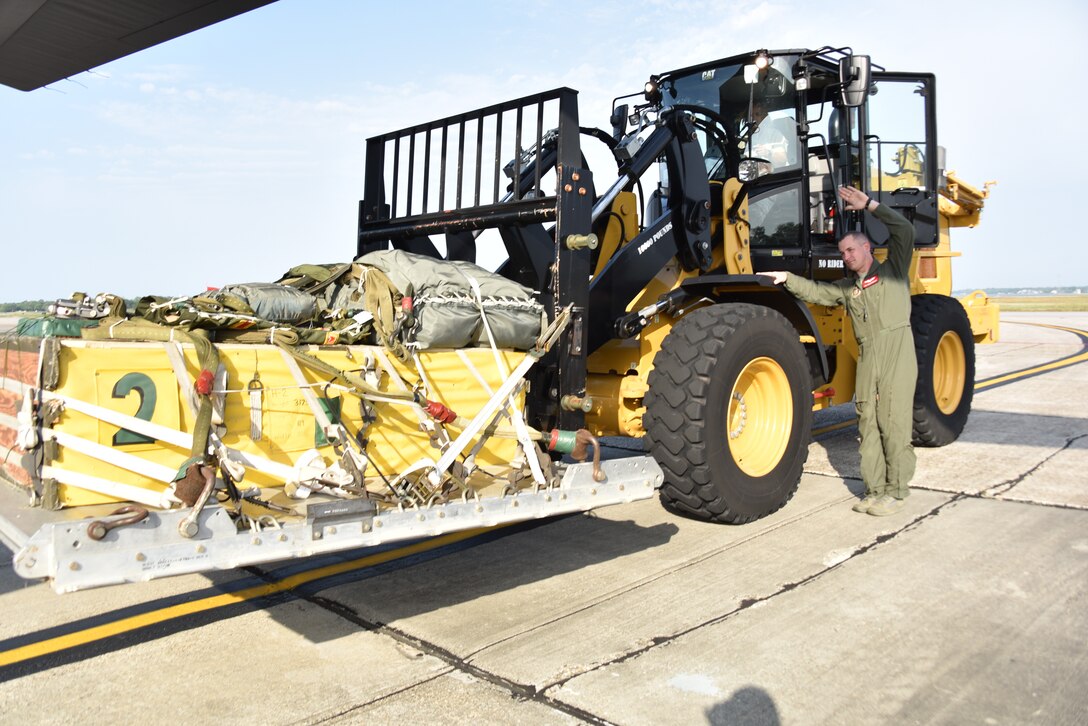 Senior Airman John Boudreaux, 815th Airlift Squadron loadmaster, guides cargo into a C-130J Super Hercules, April 18, 2019, Keesler Air Force Base, Mississippi. Boudreaux suffered three fractured vertebra in a car wreck. After receiving surgery and completing physical therapy, he attended loadmaster school for a second time and is in the process of completing his training to become a fully qualified loadmaster.  (U.S. Air Force photo by Tech Sgt. Michael Farrar)