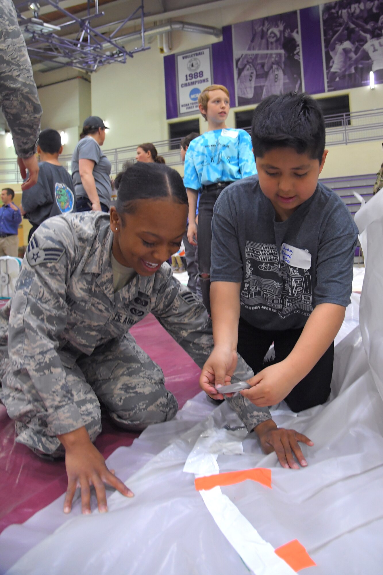 Senior Airman Alicia Grant, 775th Civil Engineer Squadron, assists a fifth grade student with building a simulated space habitat during ‘Mission to Mars’ at Weber State University May 2, 2019. Mission to Mars is facilitated by Hill Air Force Base as part of the STEM Outreach Program, which partners with local school teachers by providing a curriculum, materials and events to teach STEM-related subjects in a creative and fun environment. (U.S. Air Force photo by Todd Cromar)