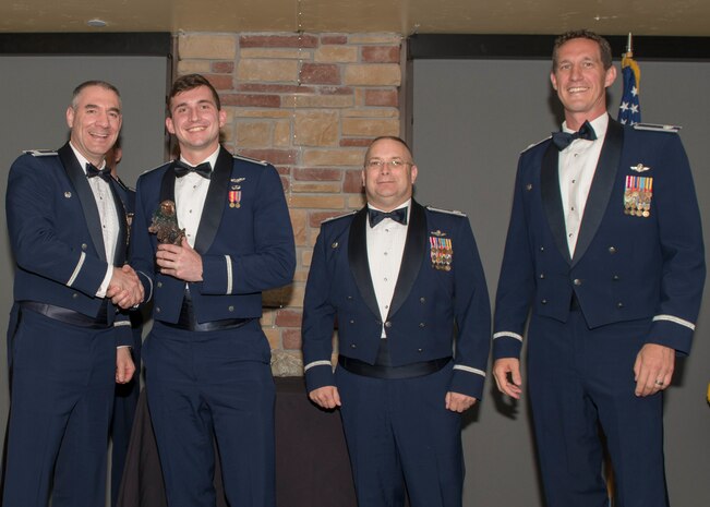 Col. Joseph Campo, 49th Wing commander, presents 1st Lt. Kent Greer, 8th FS F-16 Basic Course graduate, with an award, May 4, 2019, at Club Holloman on Holloman Air Force Base, N.M. Eight Viper pilot students graduated from the 8th FS first F-16 B-Course, nearly eighty years since the squadron's induction on Nov. 20, 1940. (U.S. Air Force photo by Airman 1st Class Kindra Stewart)