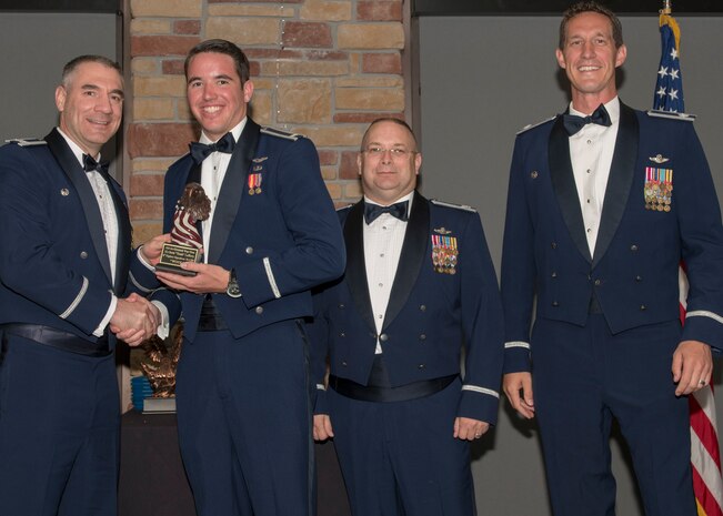 Col. Joseph Campo, 49th Wing commander, presents 1st Lt. Scott Lafferty, 8th FS F-16 Basic Course graduate, with an award, May 4, 2019, at Club Holloman on Holloman Air Force Base, N.M. Eight Viper pilot students graduated from the 8th FS first F-16 B-Course, nearly eighty years since the squadron's induction on Nov. 20, 1940. (U.S. Air Force photo by Airman 1st Class Kindra Stewart)