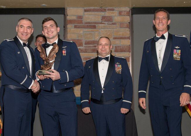 Col. Joseph Campo, 49th Wing commander, presents 1st Lt. Kent Greer, 8th FS F-16 Basic Course graduate, with an award, May 4, 2019, at Club Holloman on Holloman Air Force Base, N.M. Eight Viper pilot students graduated from the 8th FS first F-16 B-Course, nearly eighty years since the squadron's induction on Nov. 20, 1940. (U.S. Air Force photo by Airman 1st Class Kindra Stewart)