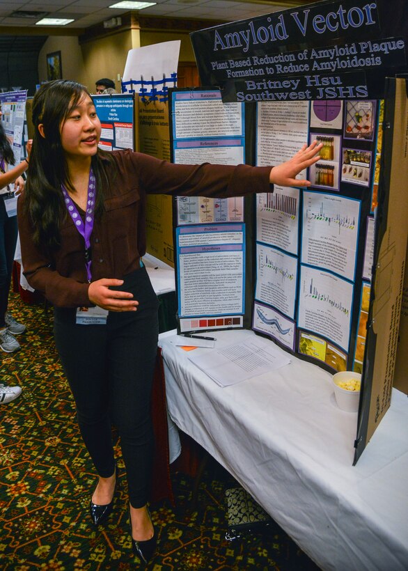 ALBUQUERQUE, N.M. -- Britany Hsu, Taos Academy Charter School, explains her poster presentation at the National Junior Science and Humanities Symposium here April 25. Hsu's presentation, "Plant Based Reduction of Amyloid Plaque Formation to Reduce Amyloidosis" detailed her research on using capsaicin as a potential treatment for Alzheimer's. The JSHS is an annual competition hosted by the Air Force, Army and Navy with more than 230 students from 47 regional competitions presenting research projects across STEM fields ranging from medicine to technology to agriculture. More than $190,000 in scholarships were awarded. The Air Force hosted this year's competition with support from Team Kirtland and the research and development sector in Albuquerque. (U.S. Air Force photo by Jim Fisher)