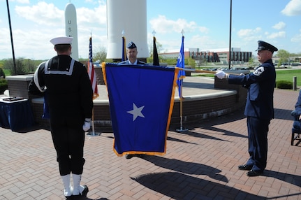 The Brigadier General flag is unfurled for Brig. Gen. Ty Neuman (center), director of the Commander’s Action Group for U.S. Strategic Command, during his promotion ceremony at Offutt Air Force Base, May 3, 2019.