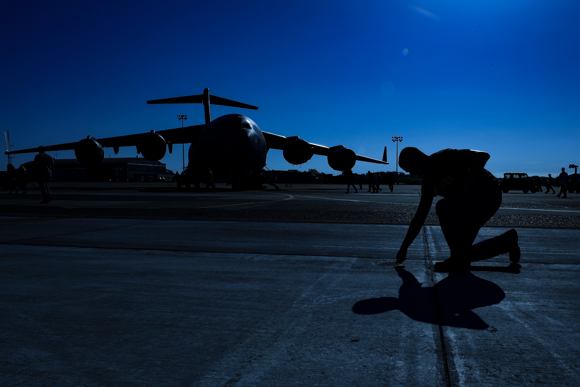 Tech. Sgt. Jason Fish, repair and reclamation/wheel and tire technician with the 911th Maintenance Group, picks up a piece of foreign object debris during a FOD walk at Pittsburgh International Airport Air Reserve Station, Pennsylvania, May 6, 2019. Performing FOD walks ensures the flightline is clear of any loose objects that could get sucked into and destroy an aircraft engine.
