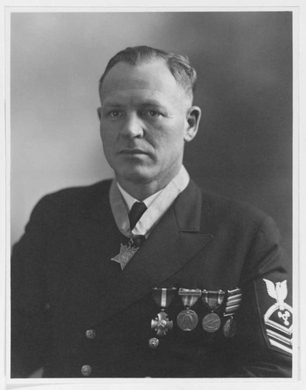 A sailor in uniform wears the Medal of Honor and four other medals.