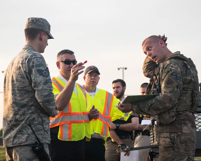 Participants during an exercise gather to discuss their plan of action on Joint Base Langley-Eustis, Virginia, April 25, 2019. Multiple organizations on base joined together to help successfully accomplish their missions during the exercise. (U.S. Air Force photo by Airman 1st Class Marcus M. Bullock)
