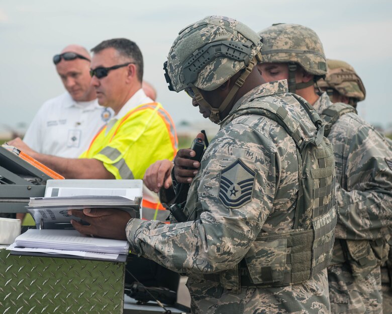 Members from the Security Forces on base coordinate during an exercise on Joint Base Langley-Eustis, Virginia, April 25, 2019. Security Forces had to set up a perimeter during the exercise to simulate a real-world scenario. (U.S. Air Force photo by Airman 1st Class Marcus M. Bullock)
