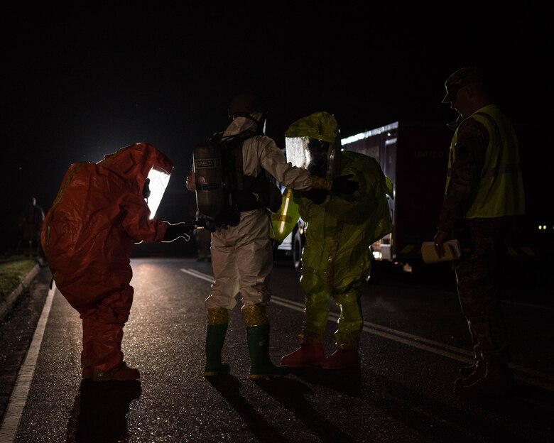 Members of Emergency Management look over a member of Explosive Ordinance Disposal during an exercise on Joint Base Langley- Eustis, Virginia, April 25, 2019. Organizations on base worked late through the night during this exercise. (U.S. Air Force photo by Airman 1st Class Marcus M. Bullock)