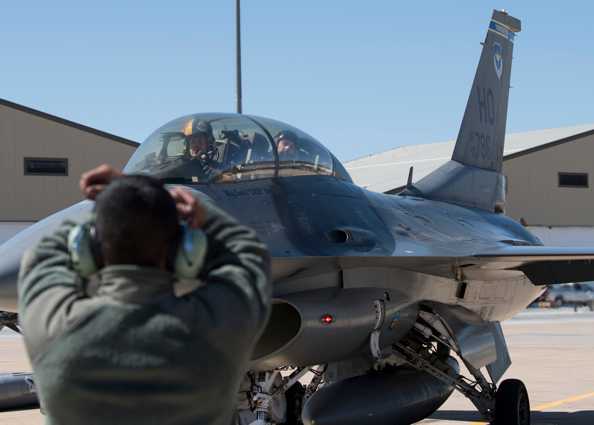 Senior Airman Dennis Labayen, 311th Aircraft Maintenance Unit Dedicated Crew Chief, signals Maj. David Abel, 311th Fighter Squadron instructor pilot, to park, May 2, 2019, on Hill Air Force Base, Utah. Abel flew the final sortie of his instructor pilot upgrade training, April 23, 2019, the first day of exercise Venom 19-01, and flew a passenger in his first familiarization flight the last day of the exercise. (U.S. Air Force photo by Staff Sgt. BreeAnn Sachs)