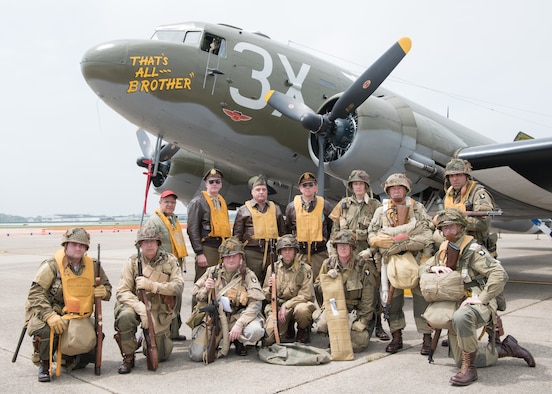 World War II reenactors pose in front of a Douglas C-47 Skytrain at the D-Day 75th Anniversary Commemoration May 4, 2019, at the Air Mobility Command Museum on Dover Air Force Base, Del. The plane was open for cabin and cockpit tours throughout the day.  (U.S. Air Force Photo by Mauricio Campino)