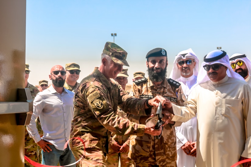U.S. Army Col. Guy Reedy, 1st Theater Sustainment Command’s Operational Command Post chief of staff,  Kuwait Col. Abdullah Hamed Al-Masamah,  Khabari Crossing operations manager, and Jamal Al-Julawi, director general of customs administration, cut the ribbon on a newly rennovated facility at Khabari Crossing, Kuwait, April 30, 2019.