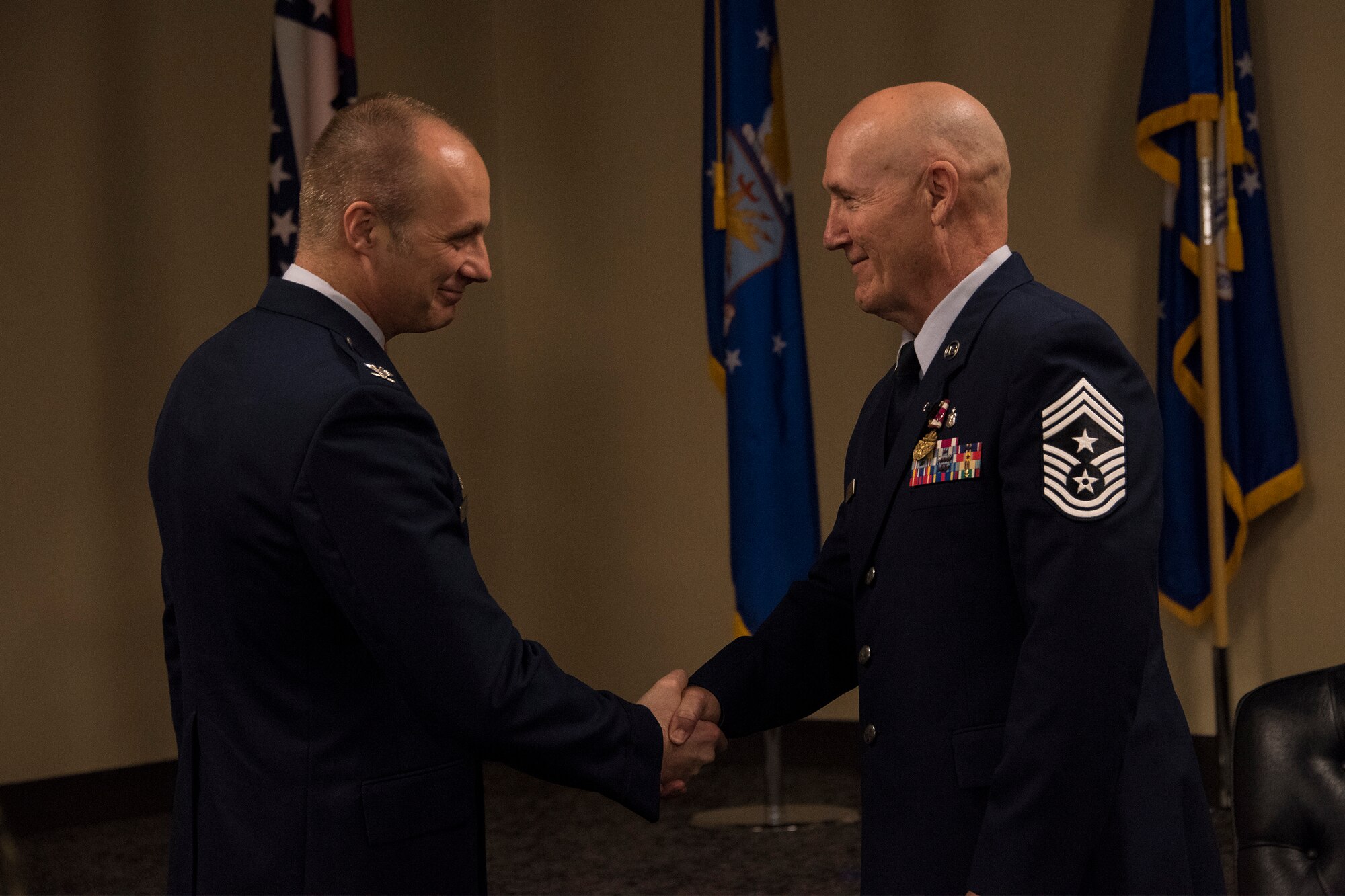 188th Wing Commander, Col. Robert I. Kinney, shakes hands with Chief Master Sgt. Stephen R. Bradley, 188th Wing command chief master sergeant, during a retirement ceremony held May 4, 2019, at Ebbing Air National Guard Base, Arkansas. Bradley served 37 years as a dental technician, first sergeant, and eventually 188th Wing command chief. (U.S. Air National Guard photo by Tech. Sgt. John E. Hillier)