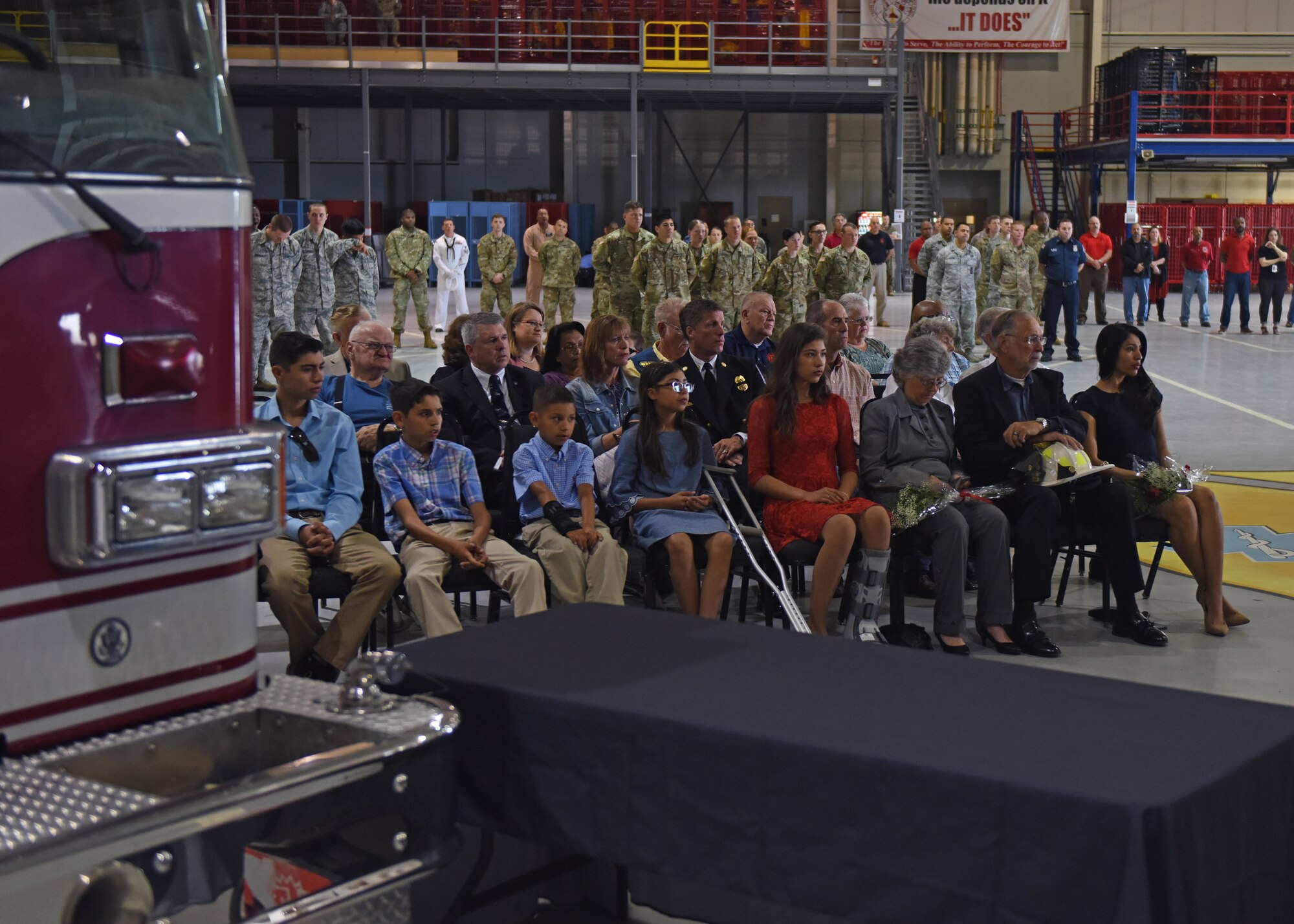 The family of Shane Hennessey attend the Firefighter Memorial Ceremony held in the Louis F. Garland Department of Defense Fire Academy High Bay at Goodfellow Air Force Base, Texas, May 3, 2019. Hennessey was recognized during the ceremony, which honors all DOD firefighters who have lost their lives. (U.S. Air Force photo by Airman 1st Class Zachary Chapman/Released)