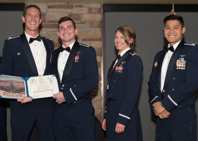 Lt. Col. Mark Sletten, 8th Fighter Squadron commander, presents 1st Lt. Kent Greer, 8th FS F-16 Basic Course graduate, with a certificate of training, May 4, 2019, at Club Holloman on Holloman Air Force Base, N.M. Eight Viper pilot students graduated from the 8th FS first F-16 B-Course, nearly eighty years since the squadron's induction on Nov. 20, 1940. (U.S. Air Force photo by Airman 1st Class Kindra Stewart)