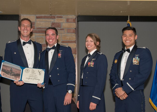 Lt. Col. Mark Sletten, 8th Fighter Squadron commander, presents 1st Lt. Scott Lafferty, 8th FS F-16 Basic Course graduate, with a certificate of training, May 4, 2019, at Club Holloman on Holloman Air Force Base, N.M. Eight Viper pilot students graduated from the 8th FS first F-16 B-Course, nearly eighty years since the squadron's induction on Nov. 20, 1940. (U.S. Air Force photo by Airman 1st Class Kindra Stewart)