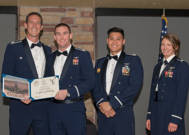 Lt. Col. Mark Sletten, 8th Fighter Squadron commander, presents Capt. Daniel Rule, 8th FS F-16 Basic Course graduate, with a certificate of training, May 4, 2019, at Club Holloman on Holloman Air Force Base, N.M. Eight Viper pilot students graduated from the 8th FS first F-16 B-Course, nearly eighty years since the squadron's induction on Nov. 20, 1940. (U.S. Air Force photo by Airman 1st Class Kindra Stewart)