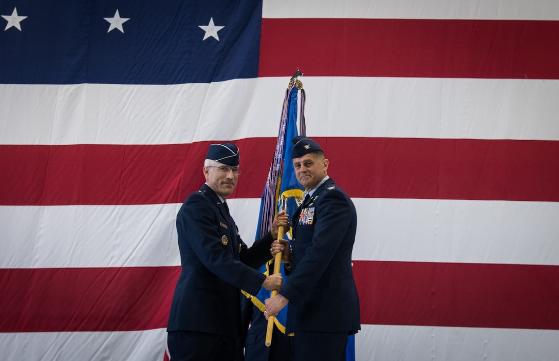 Maj. Gen. Craig La Fave, 22nd Air Force commander hands the guidon to Col. Glenn Collins, 932nd Airlift Wing commander, symbolizing the passing of the responsibilities, during the assumption of command May 5, 2019, at Scott Air Force Base, Illinois. Collins previously served as the Assistant Deputy Director of Operations and Nuclear Integration for Air Mobility Command before assuming command of the 932nd AW. (U.S. Air Force photo by Senior Airman Melissa Estevez)