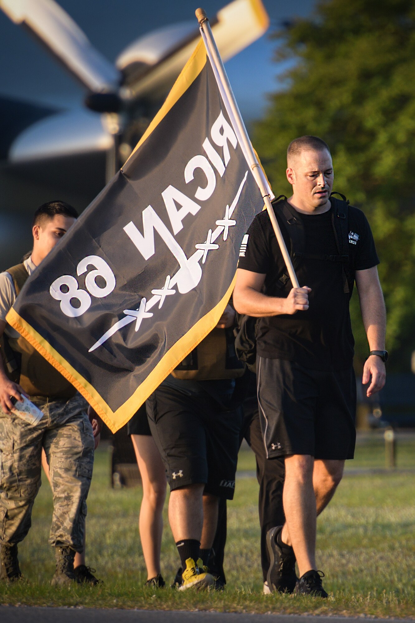 Tech Sgt. Wesley Cunningham, 628th Air Base Wing religious affairs specialist, carries the Rican 68 flag during a nine-mile ruck May 1, 2019 at Joint Base Charleston, S.C.